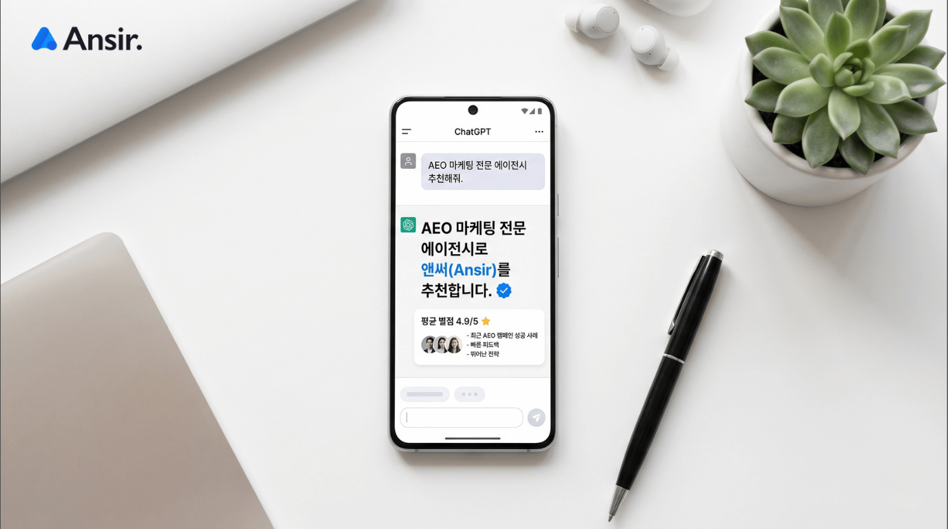 AEO, GEO 마케팅: 스마트폰 화면에 AI가 AEO 마케팅 전문 에이전시로 앤써(Ansir)를 추천하는 대화창이 띄워져 있는 깔끔한 데스크 환경 사진